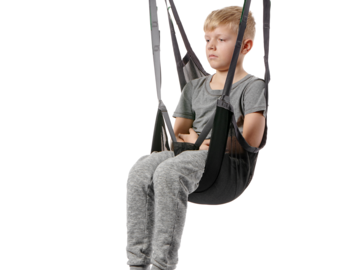 Child seated in a Guldmann Sit-On II Kids sling suspended from a ceiling hoist for safe and comfortable lifting.