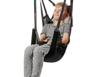 Child seated securely in a Guldmann Sit-On High II Kids sling suspended from a ceiling hoist.