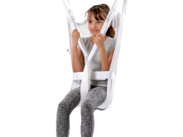 Child seated in a Guldmann Disposable High Kids sling suspended from a ceiling hoist for safe patient lifting.