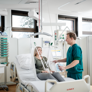 Provide dignified patient care with the support of a ceiling hoist system.