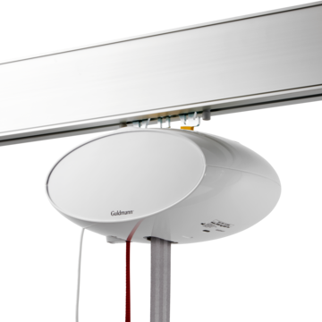 GH1 ceiling hoist module with white cover plate, mounted on a rail for lifting support