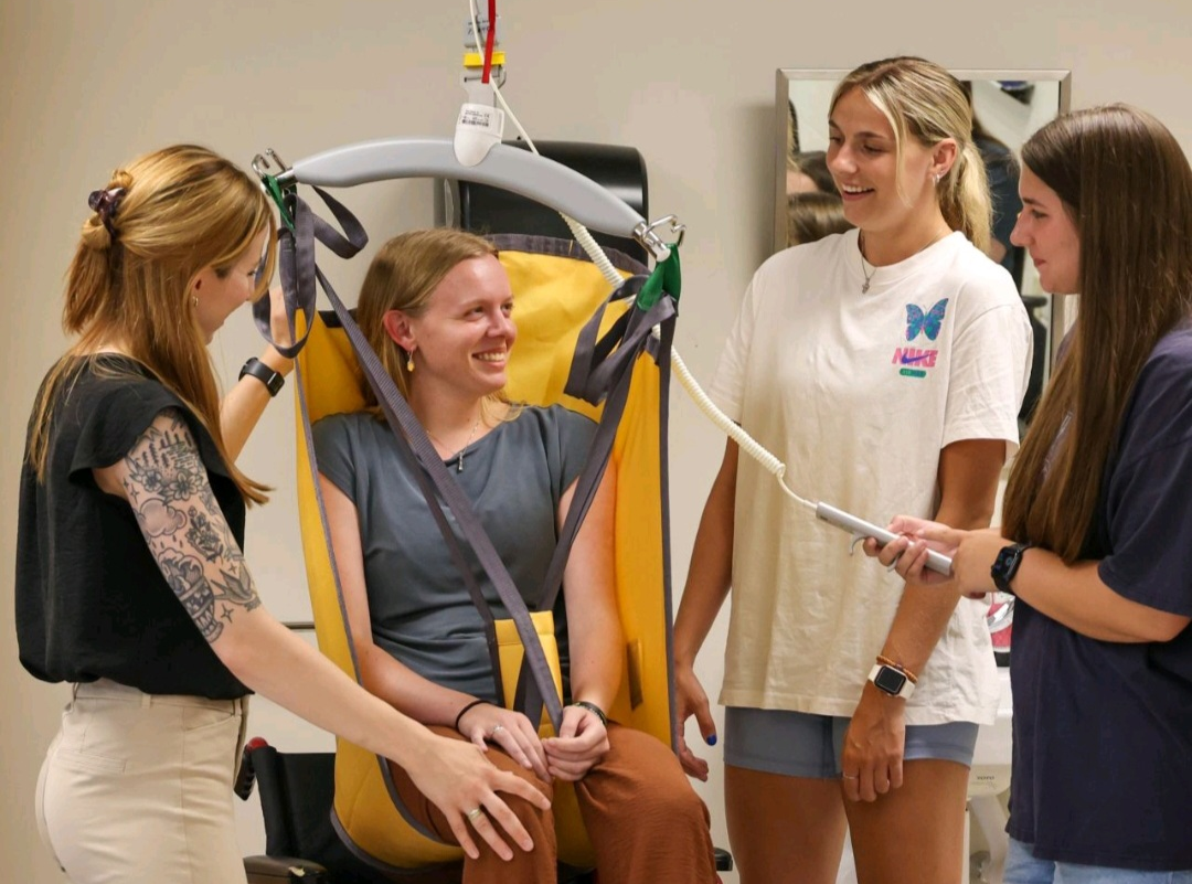 Occupational therapy students at Elizabethtown College practicing patient transfer exercises using the Guldmann GH3+ ceiling lift with Trainer Module.
